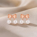 JewelMaze Rose Gold Plated Bow Shape Austrian Stone & Pearl Stud Earrings for Women 